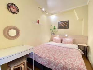 a small bedroom with a bed and a desk at Milne Apartments in Saint Petersburg