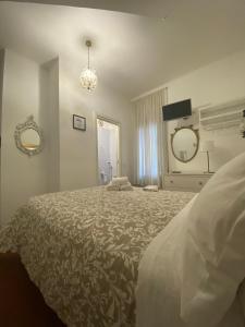 a bedroom with a large bed and two mirrors at Al Ponte Del Papa B&B in Rome
