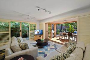 a living room with two couches and a television at Alderly Terrace in Noosa Heads