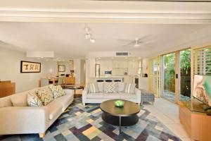 a living room with a couch and a table at Alderly Terrace in Noosa Heads