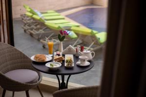 a table with a tray of breakfast food on it at Opera Hotel 