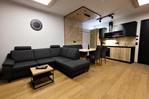 a living room with a couch and a table at Moderne Wohnung mit einer wunderschönen Aussicht in der Residenz Silvretta, inkl Silvretta Card Premium in See