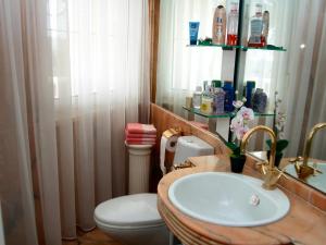 a bathroom with a white toilet and a sink at Villa Vistabella in Chayofa +15 photos