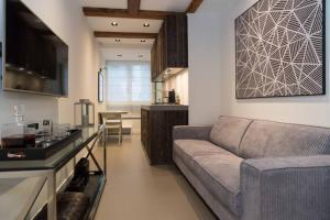 a living room with a couch and a kitchen at Canal Dream Apartment in Amsterdam