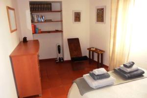 a room with a bedroom with a bed and a desk at Casa de S. Domingos in Évora +23 photos