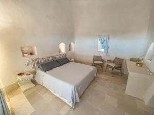 Postel nebo postele na pokoji v ubytování Relais Masseria Capasa