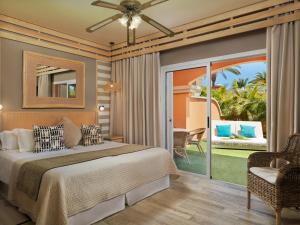 a bedroom with a large bed and a large window at Green Garden Eco Resort & Villas in Playa de las Americas