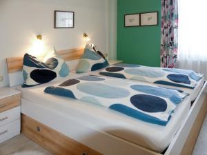 ノイキルヒェン・アム・グロースヴェンエーディガーにあるApartment Stainer - NKI125 by Interhomeのベッド(青と白のシーツ、枕付)