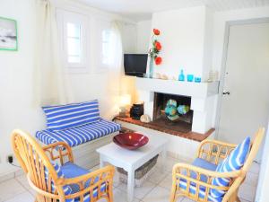 a living room with a couch and chairs and a fireplace at Holiday Home Les Vives by Interhome in Narbonne-Plage