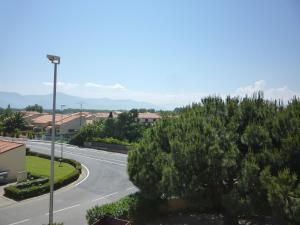 an empty street in a town with a road at Apartment Les Terrasses Fleuries by Interhome in Saint-Cyprien-Plage