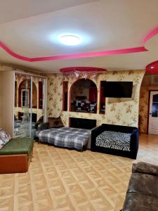 a bedroom with two beds and a flat screen tv at Мини-отель in Kropyvnytskyi