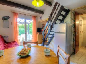 a kitchen and dining room with a table and a refrigerator at Holiday Home Port Sud by Interhome in Saint-Cyprien-Plage