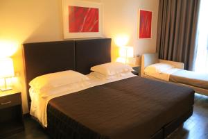 a hotel room with a bed and two beds at Park Hotel Sporting in Teramo
