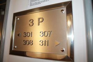 a metal plaque on a wall with the number of pi at Park Hotel Sporting in Teramo