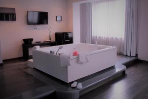 a large white bath tub in a room at Park Hotel Sporting in Teramo