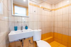 a bathroom with a toilet and a sink at Fotis Apartments in Artemida