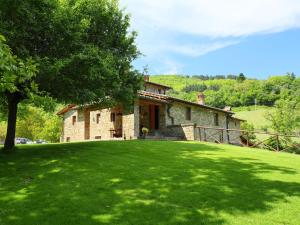 a house in a field with a green lawn at Holiday Home Lucolena by Interhome in Lucolena in Chianti