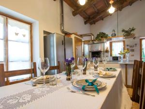 a dining room table with a white table cloth and wine glasses at Villa Camporbiano by Interhome in Camporbiano