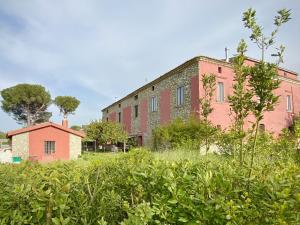 an old brick building in a field of bushes at Tenuta TerraRossa in Rossano