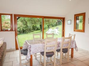a dining room with a table and chairs at Holiday Home Bella Vista by Interhome in Saint-Suliac