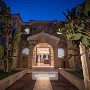a house with an archway in front of a building at Villa Kristia in Paphos City