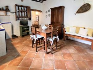 a kitchen with a table and chairs and a couch at Apartment Taverna by Interhome in Montecatini Val di Cecina