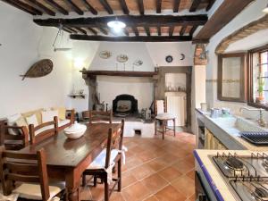 a kitchen and dining room with a table and a fireplace at Apartment Taverna by Interhome in Montecatini Val di Cecina