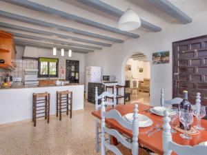 a kitchen and living room with a table and chairs at Holiday Home Forest by Interhome in Benitachell