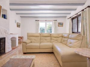 a living room with a couch and a fireplace at Holiday Home Forest by Interhome in Benitachell