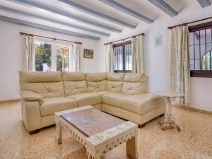a living room with a couch and a coffee table at Holiday Home Forest by Interhome in Benitachell