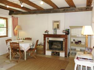 a dining room with a table and a fireplace at Holiday Home Marray-Baccus - OZN200 by Interhome in Onzain