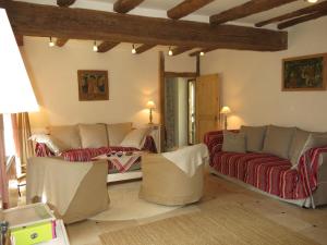 a living room with couches and tables in a room at Holiday Home Marray-Baccus - OZN200 by Interhome in Onzain