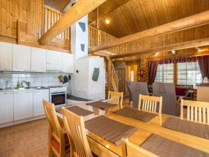a kitchen and dining room with a table and chairs at Holiday Home Keisarintupa by Interhome in Ruka