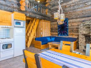a kitchen and dining room with a table and a stove at Holiday Home Rinnekieppi 2 by Interhome in Ruka
