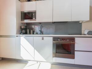 een keuken met witte kasten en een oven bij Holiday Home Poropahta b by Interhome in Ruka