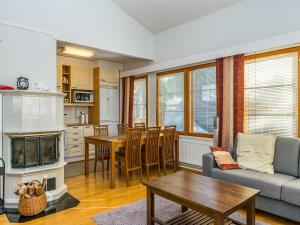 a living room with a couch and a table at Holiday Home Karhunvartijan pirtti c4 by Interhome in Ruka