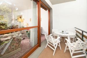 um quarto com uma varanda com uma mesa e cadeiras em Imperiale Apartment em Forte dei Marmi