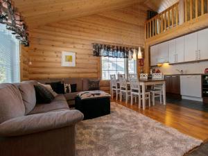 a living room with a couch and a table and a kitchen at Holiday Home Sini-ruka 1 by Interhome in Ruka