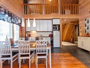 a kitchen with a table and chairs in a room at Holiday Home Sini-ruka 1 by Interhome in Ruka