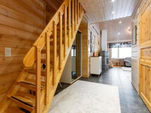 a staircase in a room with wooden walls at Holiday Home Sini-ruka 1 by Interhome in Ruka