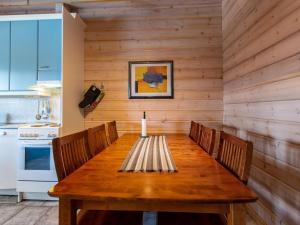 a dining room with a wooden table and chairs at Holiday Home Ruka snow & sun 1 by Interhome in Ruka