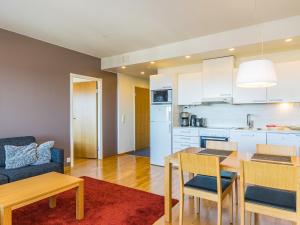 a kitchen and living room with a table and chairs at Holiday Home Ruka ski chalets 64- 1503 by Interhome in Ruka