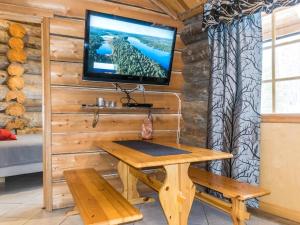 ein Raum mit einem Tisch und einem Fernseher an der Wand in der Unterkunft Holiday Home Kekkonen 1 by Interhome in Levi + 7 Fotos