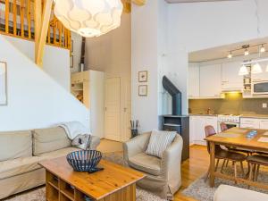 a living room with a couch and a table at Holiday Home Karhunvartijan linna c22 by Interhome in Ruka