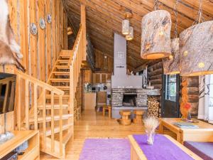 a log cabin kitchen and living room with wooden walls at Holiday Home Saaruanaho h1 by Interhome in Ruka