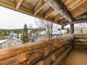 a log fence on the deck of a cabin with a view at Holiday Home Saaruanaho h1 by Interhome in Ruka
