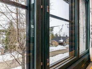 an open window with a view of a snow covered yard at Holiday Home Saaruanaho h1 by Interhome in Ruka