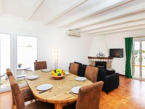 a living room with a wooden table and a dining room with a tablektop at Holiday Home Afrodita by Interhome in L'Escala