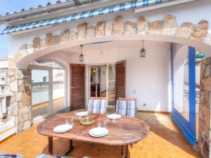 a dining room with a wooden table and an archway at Holiday Home Afrodita by Interhome in L'Escala