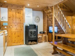 ein Wohnzimmer mit einem Holzofen in einer Hütte in der Unterkunft Holiday Home Hirvas levi 4 by Interhome in Levi